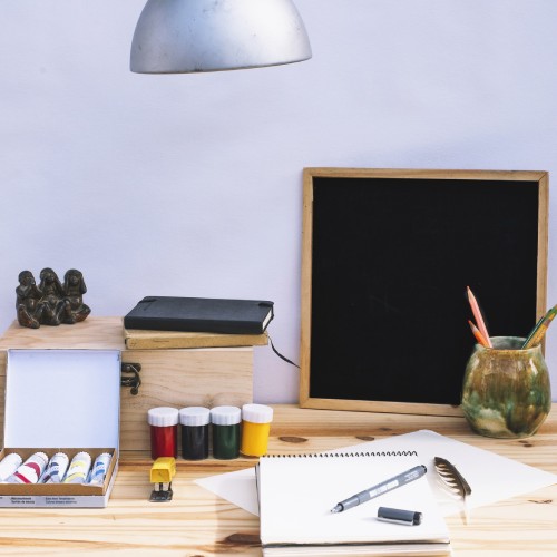 Desk with crafting materials for a blog on custom vs DIY